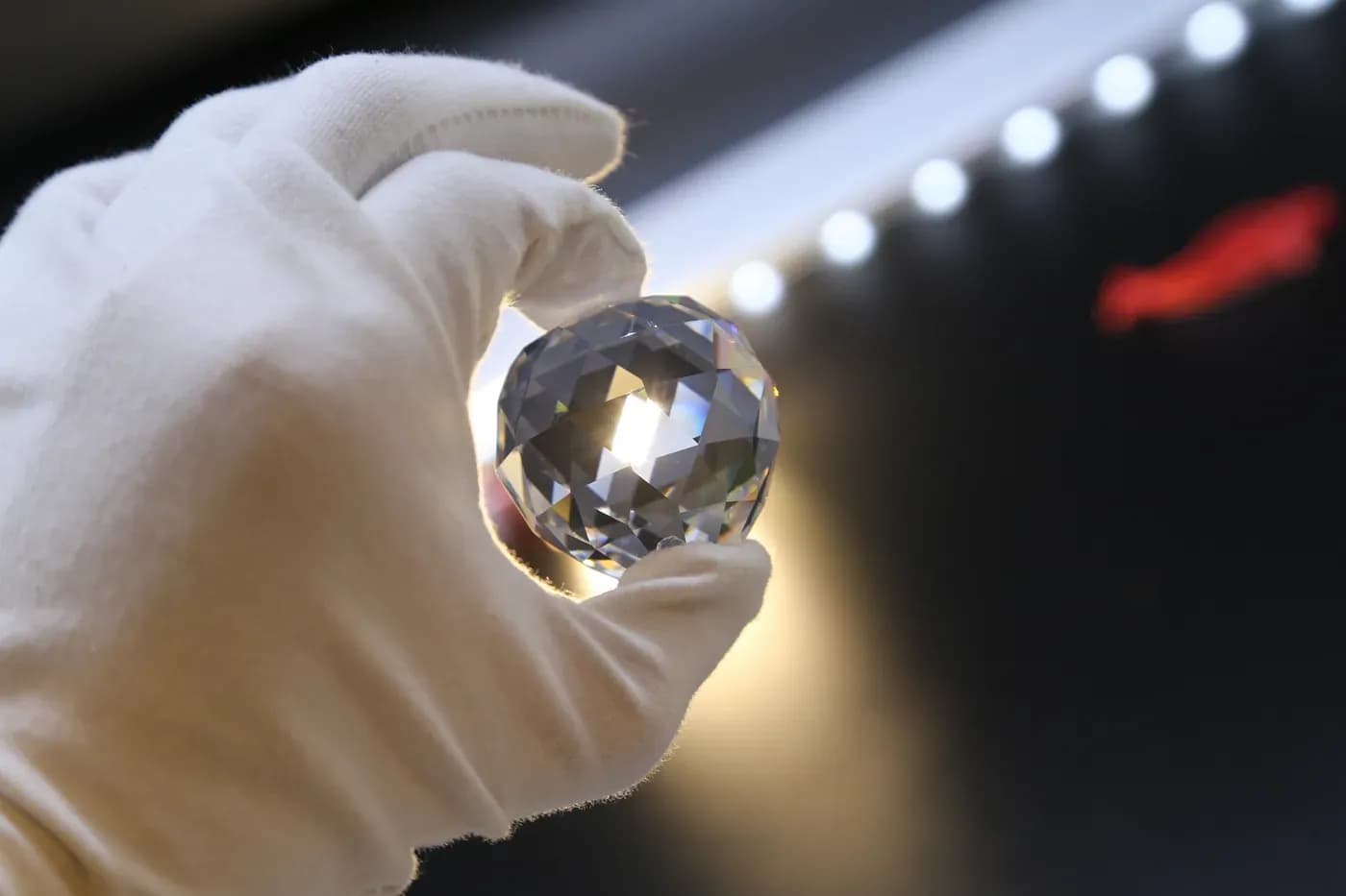 Crystal sphere inspected against light for clarity and consistency