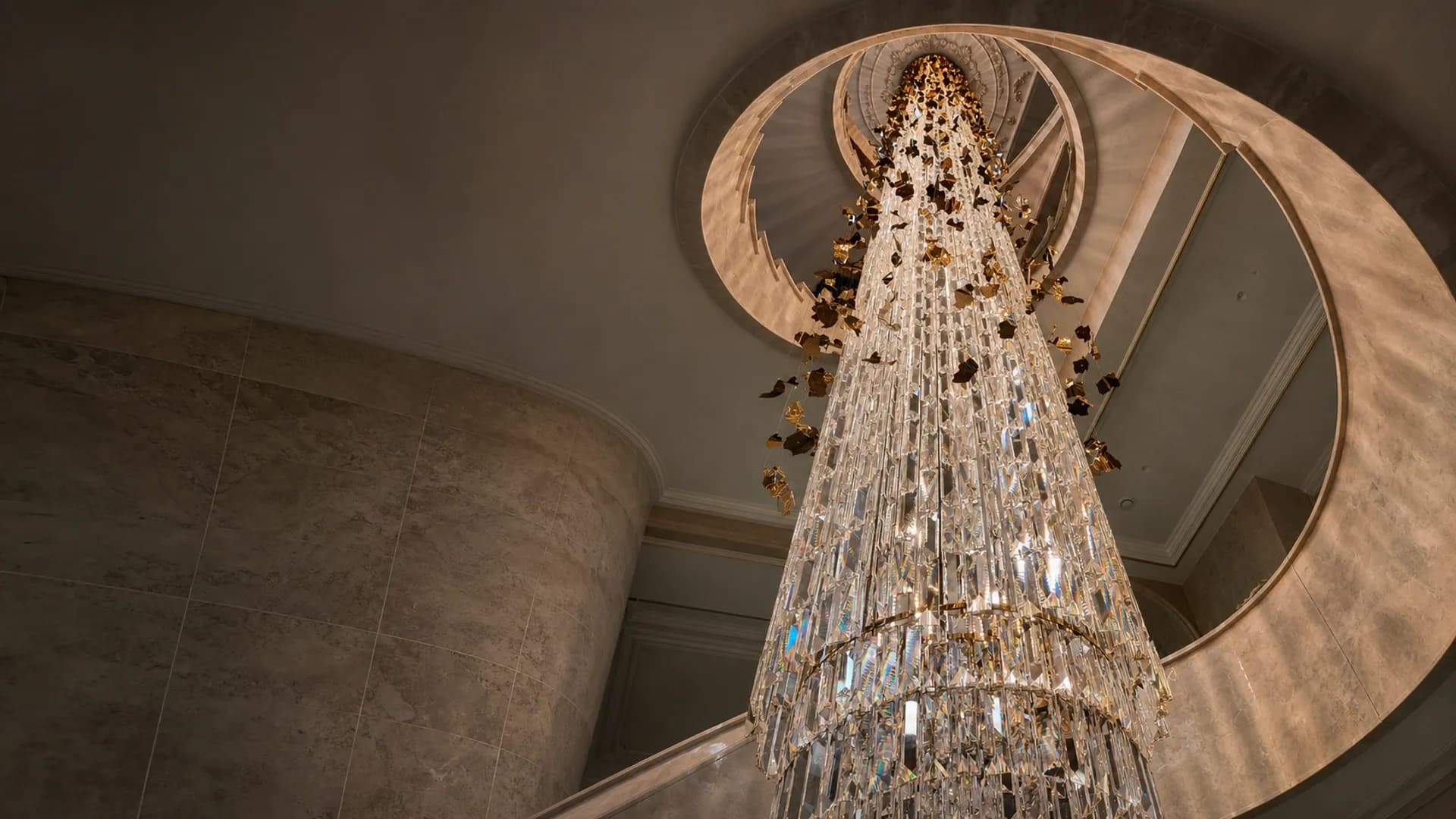 Floor-to-ceiling crystal chandelier in a private residential staircase