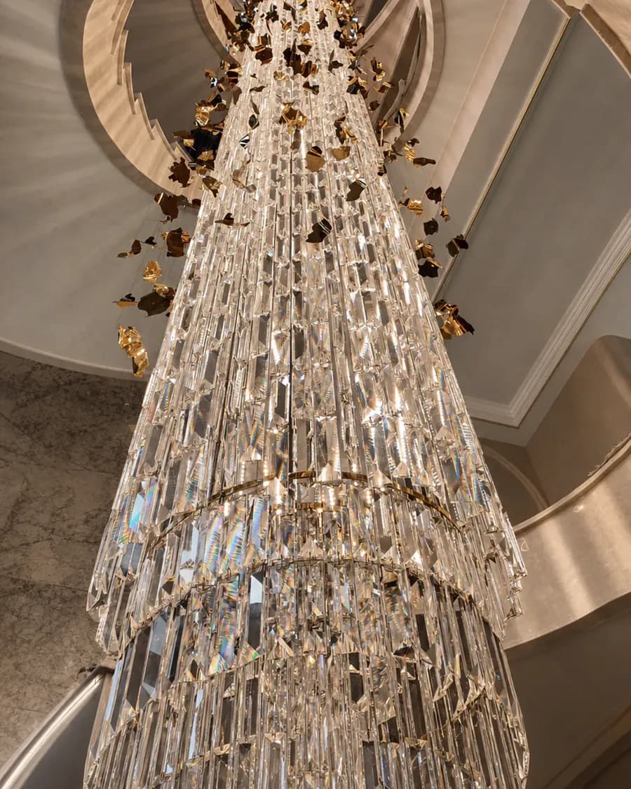 Floor-to-ceiling crystal chandelier in a private residential staircase