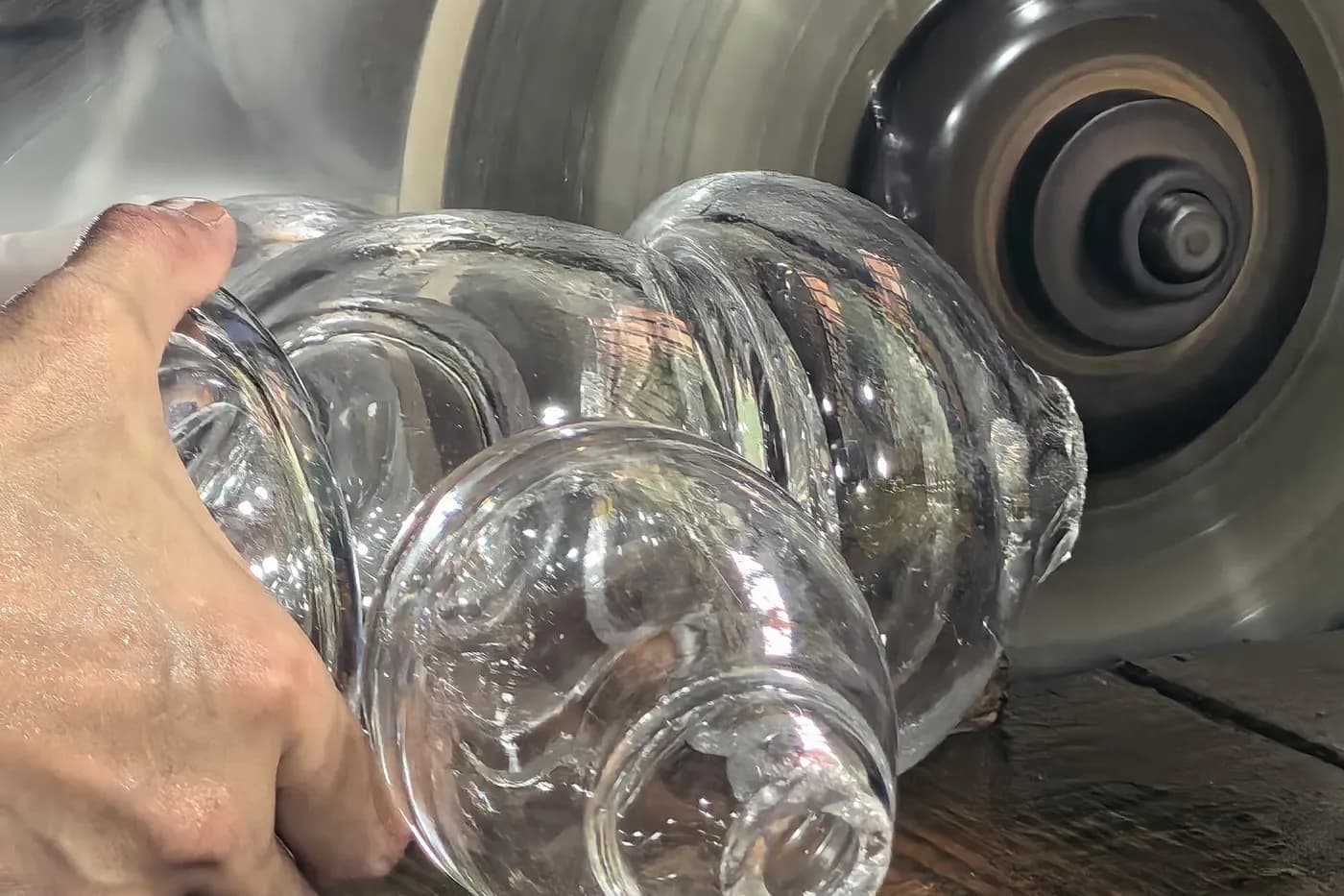 Hand polishing a transparent glass component for bespoke lighting