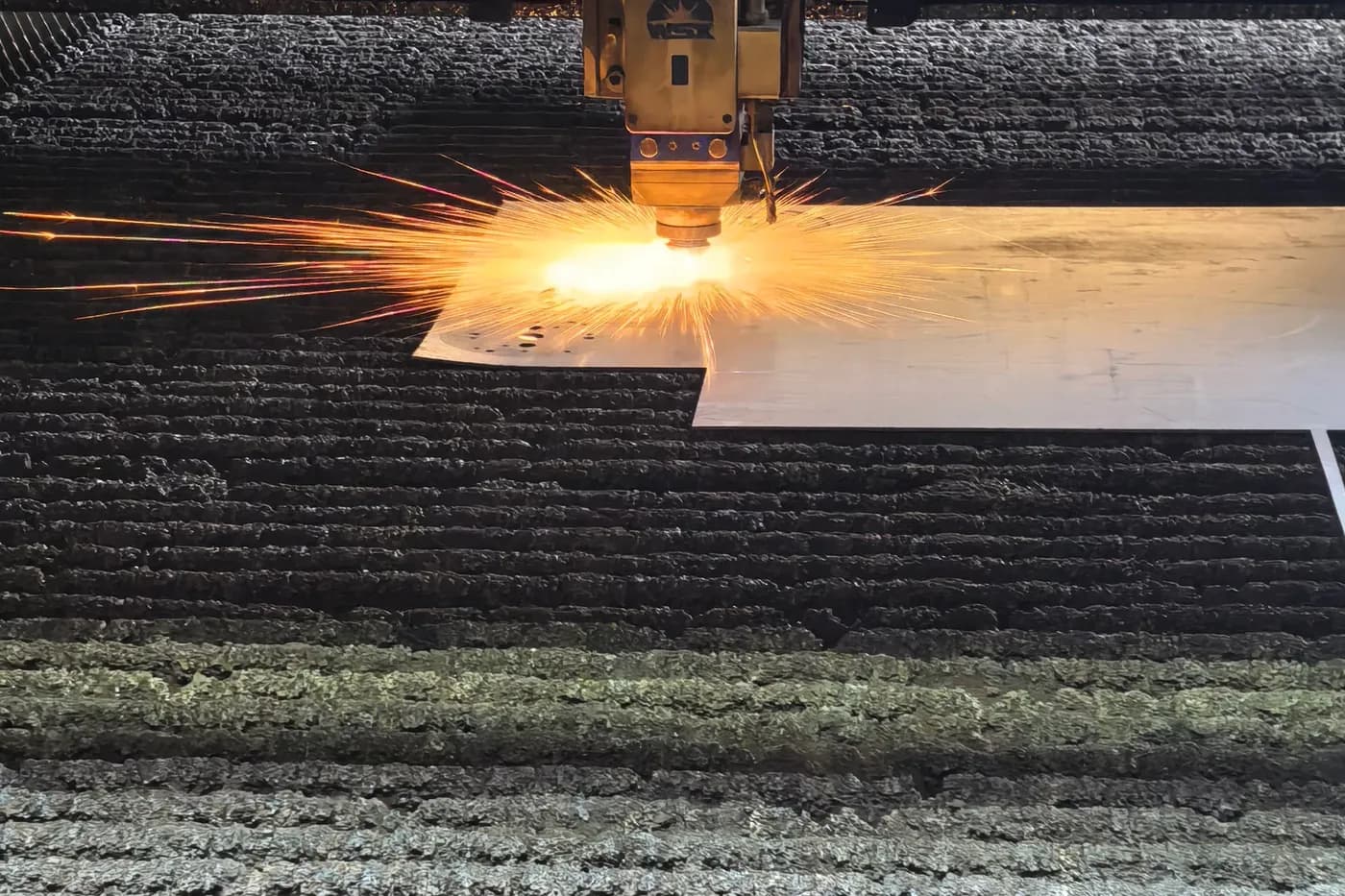 Laser cutting metal components for a custom lighting structure