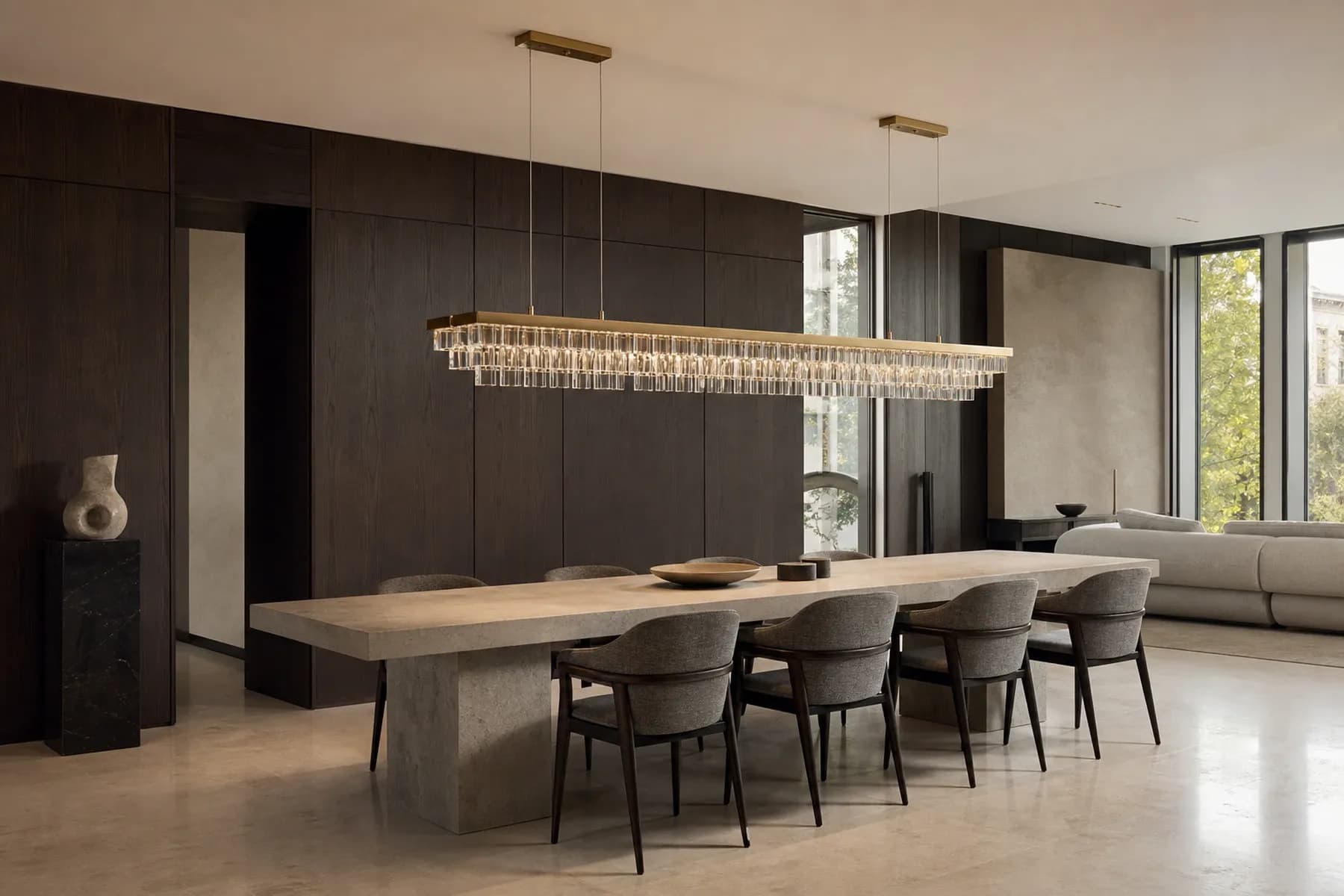 Milan dining room with a layered linear crystal chandelier above a stone table